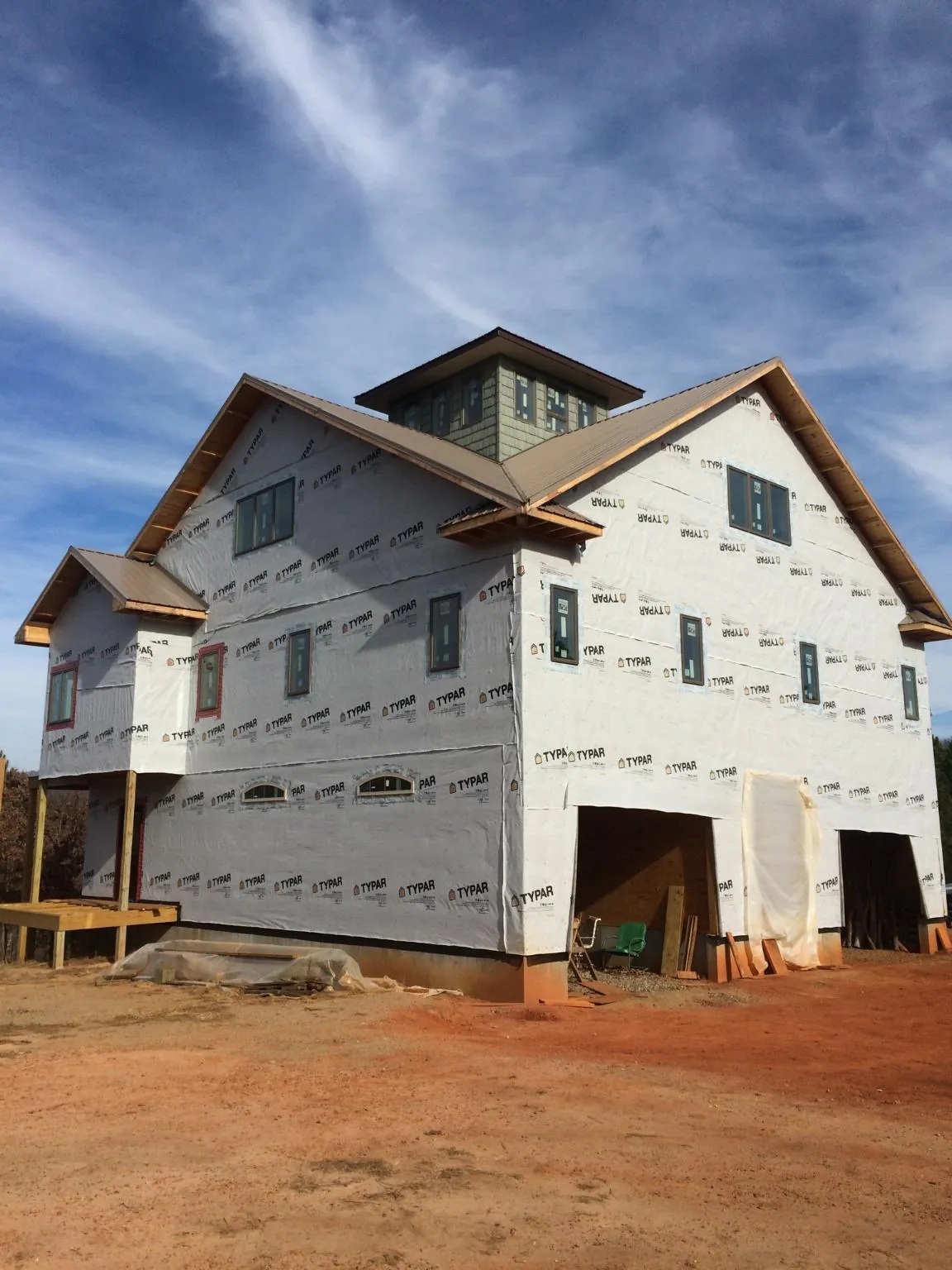 New two story house under construction with a cupola and gabled roofs in Ratliff City